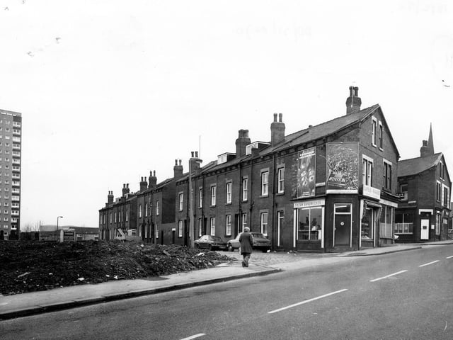 Domestic Street showing the junction with Pleasant Place in the centre. Terraced housing on Pleasant Place can be seen with Capel's Bakers at the end of the row.  Next to this is Joe's Cafe.