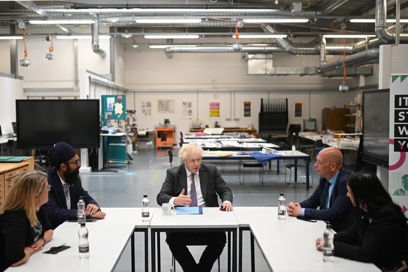 Prime Minister Boris Johnson chats with teachers in the arts and design area. Photo: Getty Images