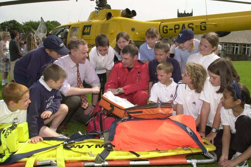 The Yorkshire Air Ambulance touched down at Calverley C of E Primary. Pictured is  MP Paul Truswell talking to paramedic Dave Hey surrounded by pupils.
