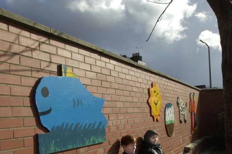 Pupils Nathan Gill and Nafisah Rehman with some of the mural boards in the playground at Ingram Road Primary School in February 2000.