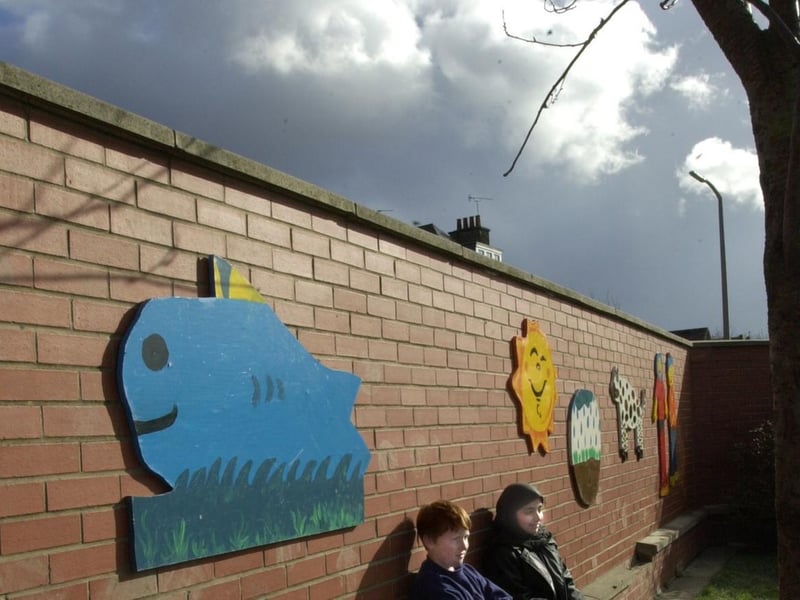 Pupils Nathan Gill and Nafisah Rehman with some of the mural boards in the playground at Ingram Road Primary School in February 2000.