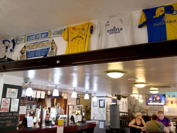 Leeds United shirts on the walls of The Drysalters, Elland Road.