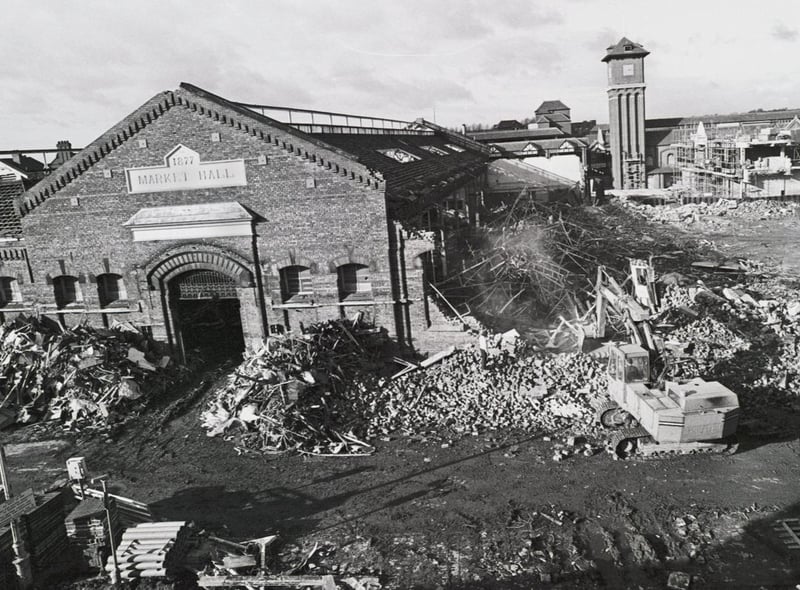One of the last ever pictures taken of the old Wigan Market Hall before demolition in 1988. The clock tower of the new market and Galleries can be seen rising in the background.