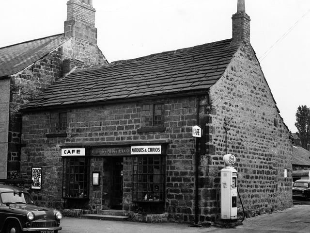 Stainthorp's Cafe and Antiques and Curios shop on Main Street in August 1974. There is a petrol pump at the side of the building and a car parked on the road.