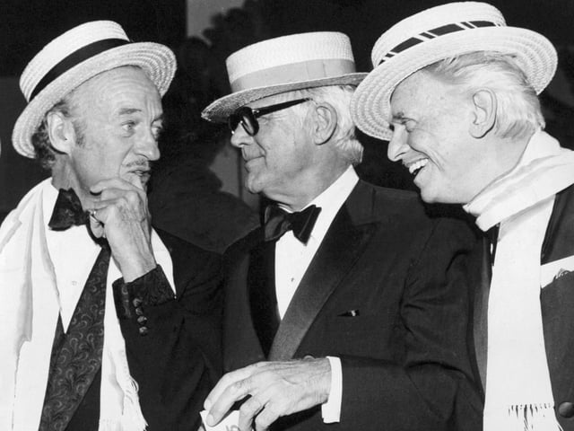 David Niven, Cary Grant and Douglas Fairbanks Junior share a joke during a Roaring Twenties ball held at the Queens Hotel in October 1974.