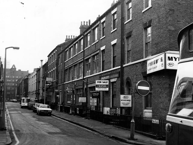 York Place from the junction with Queen Street in January 1974. Businesses in view include Myers Bros, Hat and Cap Merchants, Harry Sugar Textiles, Leeds Exchange Drapery Warehouse, Lewis Stuart Textiles and Hutchison Tailors.