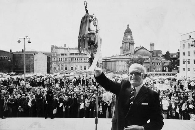 Leeds United chairman Manny Cussins displays the League Championship Trophy outside the Civic Hall during the reception for the team in July 1974.