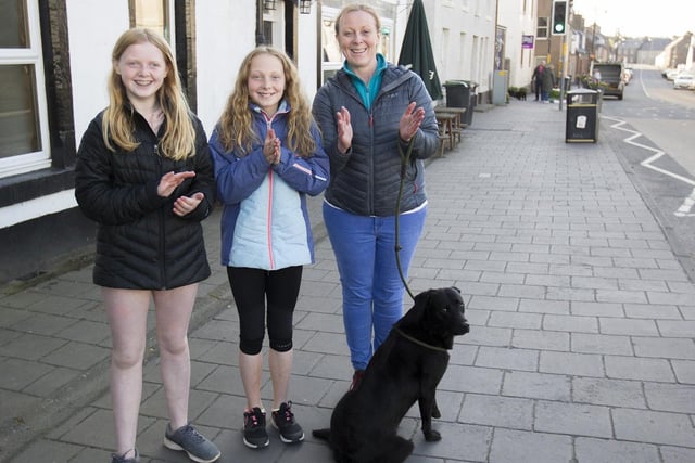 Emily, Holly and Sarah Fortune take time with their dog Jet to clap for the NHS and our key workers.