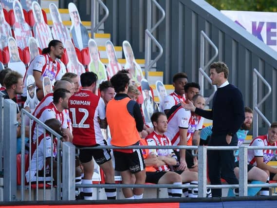 Matt Taylor spoke to his players in the stands after their semi-final win over Colchester.