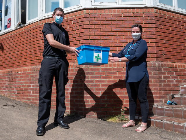 More than 2,000 deliveries of essential medication have now been delivered by firefighters to some of the most vulnerable people across the county.
Northamptonshire Fire and Rescue Service (NFRS) was asked to support the community resilience partnership response to the pandemic by aiding in pharmacy deliveries to those who are shielding and need to stay at home as they are particularly at risk from Covid-19. Pictured, on-call firefighter Ashley Hunt with Natalia Sybilska, a dispenser from Earls Barton Pharmacy