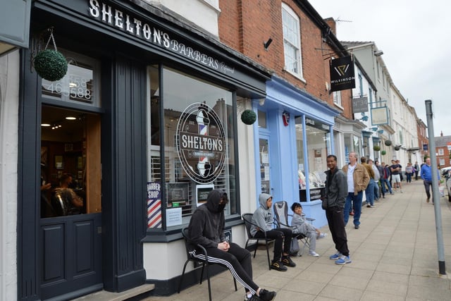 Busy scenes outside Shelton's barbers on the High Street.