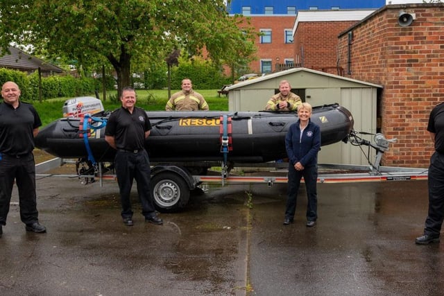 This image was taken after a crew at Wellingborough Fire Station and Community Safety Officer Jo Gouldson held a water safety Facebook live event on the NFRS Facebook page. As part of that, they held a competition for the public to rename the water rescue boat. The name Captain Tom was chosen. This photo shows firefighters from Wellingborough with Jo Gouldson (second from right) with the boat.