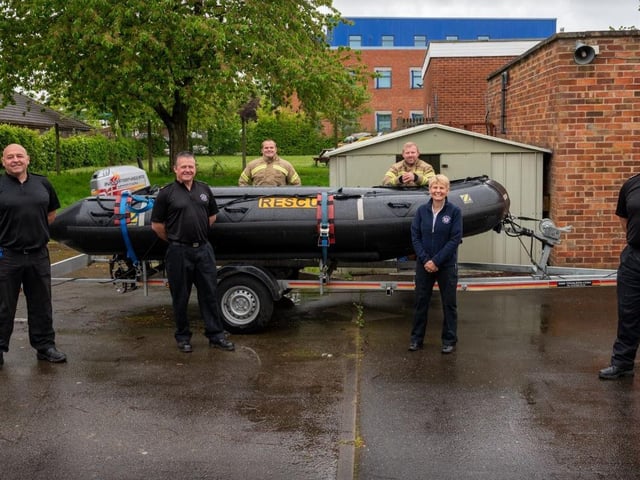 This image was taken after a crew at Wellingborough Fire Station and Community Safety Officer Jo Gouldson held a water safety Facebook live event on the NFRS Facebook page. As part of that, they held a competition for the public to rename the water rescue boat. The name Captain Tom was chosen. This photo shows firefighters from Wellingborough with Jo Gouldson (second from right) with the boat.