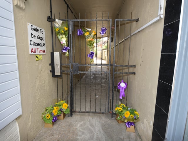 Flowers in memory of Kayleigh Hanks at the gates to her old flat in London Road, Bexhill. SUS-200721-130744001