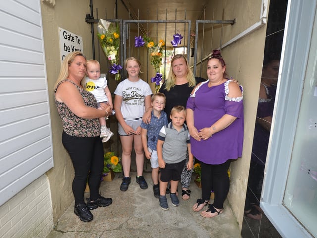 Flowers in memory of Kayleigh Hanks at the gates to her old flat in London Road, Bexhill. SUS-200721-130818001