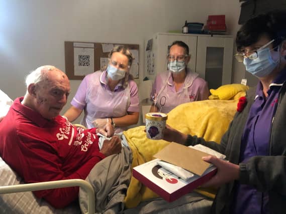 Mr John Widdop with his carers Coaral Gotham, Hannerie Keyser in lilac tunics and Sharon Prendergas celebrating his 90th birthday