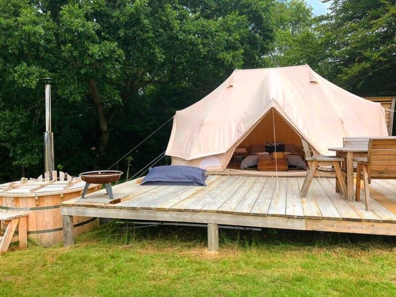 A unique eco-camping experience in emperor tents that sleep four adults/family of six. Each tent has a camp stove, electrical points, private kitchen and bathroom, wood fired hot tub and private decking area.