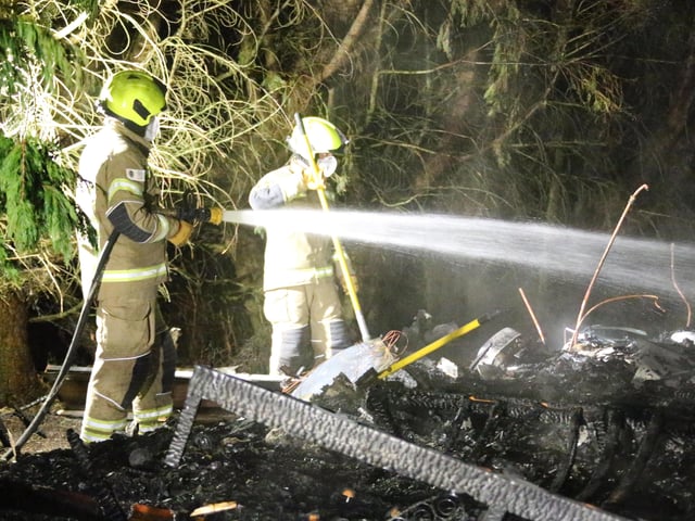 Firefighters wearing breathing apparatus used two high pressure hose reels to bring the building fire under control.