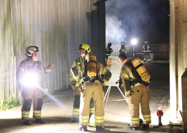Firefighters wearing breathing apparatus used two high pressure hose reels to bring the building fire under control.