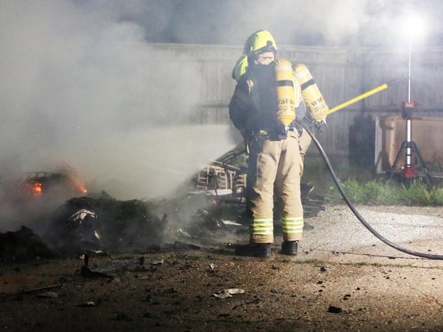 Firefighters wearing breathing apparatus used two high pressure hose reels to bring the building fire under control.