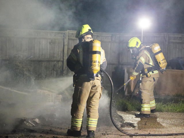 Firefighters wearing breathing apparatus used two high pressure hose reels to bring the building fire under control.