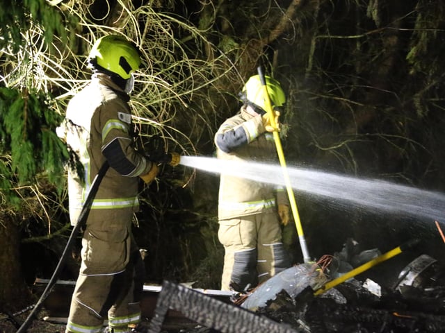 Firefighters wearing breathing apparatus used two high pressure hose reels to bring the building fire under control.