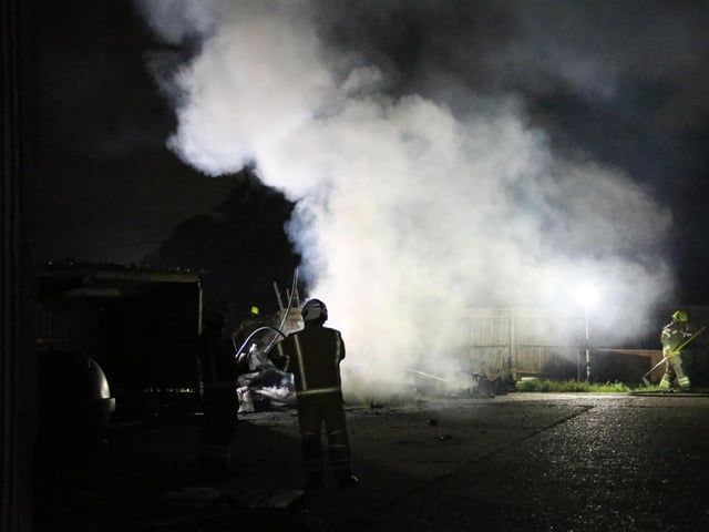 Firefighters wearing breathing apparatus used two high pressure hose reels to bring the building fire under control.