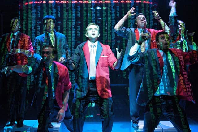 ENRON: Ashley Rolfe (centre) and the Traders. Photo by Manuel Harlan