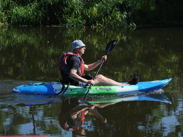 Bank Holiday Monday - canoeist on the River Nene EMN-200525-212021009