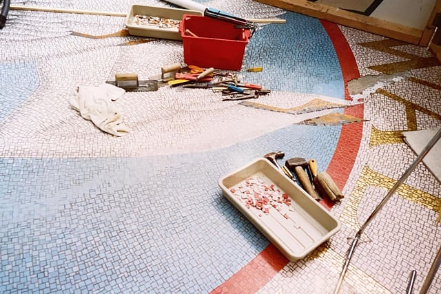 The final mosaic pieces going in at Swan Walk