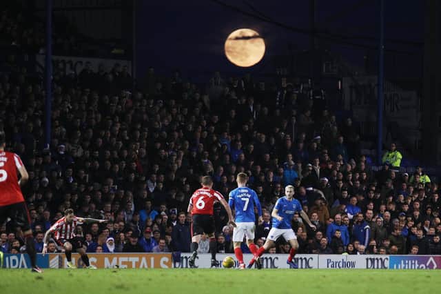 A full moon peers over the North Stand and its occupants / Picture: Joe Pepler