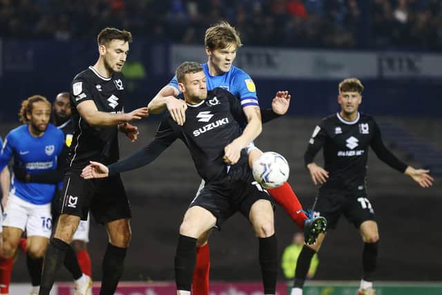 MK Dons - pictured in action at Pompey last month - have closed the gap on League One's top two / Picture: Joe Pepler