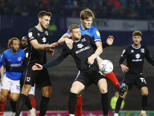 MK Dons - pictured in action at Pompey last month - have closed the gap on League One's top two / Picture: Joe Pepler
