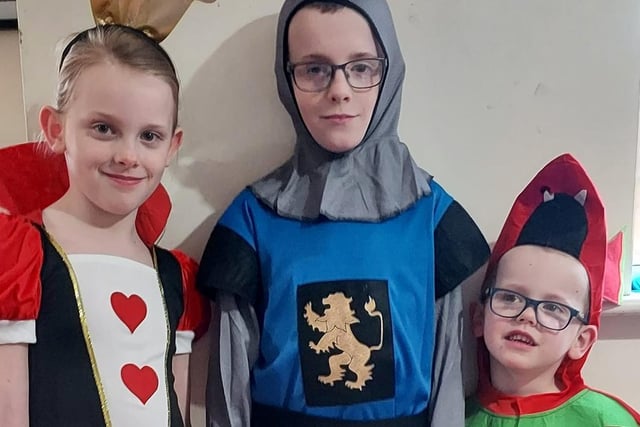 Queen of Hearts Hannah-Louise, seven; knight John Paul, 10; and Kristian-Lee, four, a friendly dragon