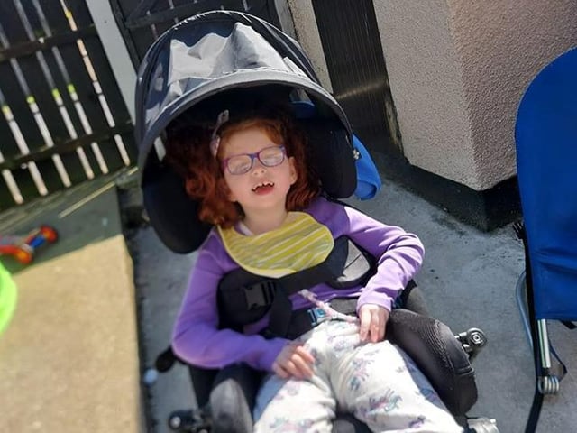 Clar Mac: "Sunbathing in lockdown out the back. Cara, age 8 yrs with cerebal palsy, still smiling".