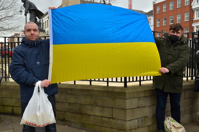 Demonstrators carry a Ukrainian flag at the Derry Anti-War Coalition’s ‘No to War - Oppose Putin’s Invasion - Stop NATO expansion’ rally at the Diamond on Saturday afternoon last. Photo: George Sweeney.  DER2208GS – 104