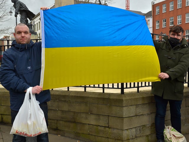 Demonstrators carry a Ukrainian flag at the Derry Anti-War Coalition’s ‘No to War - Oppose Putin’s Invasion - Stop NATO expansion’ rally at the Diamond on Saturday afternoon last. Photo: George Sweeney.  DER2208GS – 104