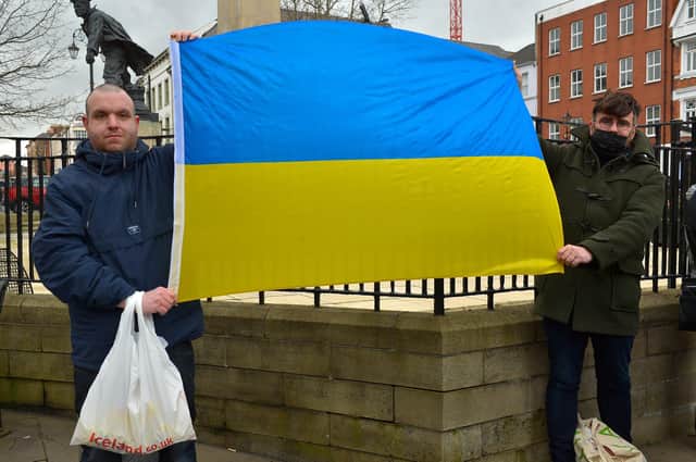 Demonstrators carry a Ukrainian flag at the Derry Anti-War Coalition’s ‘No to War - Oppose Putin’s Invasion - Stop NATO expansion’ rally at the Diamond on Saturday afternoon last. Photo: George Sweeney.  DER2208GS – 104