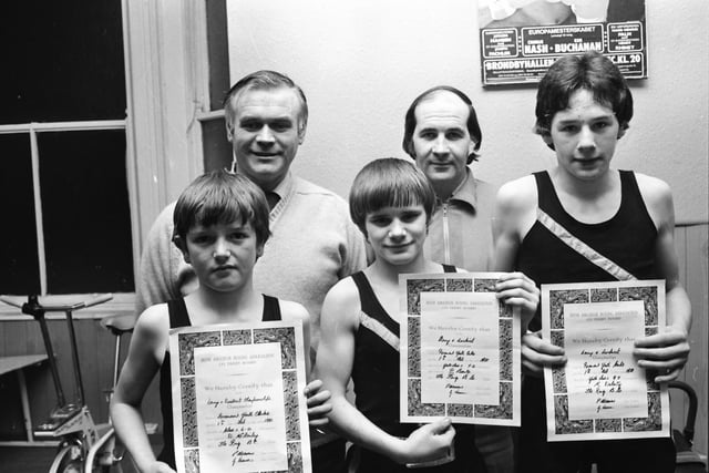 Boxers from the Ring ABC, Lawrence Hill, who were winners at the Derry and District Boxing Championships. From left, Denis McGinley, 6 st. champion, Paul Burke, 7 st. champion, and Kevin Doherty, 9 st. 7 lb. champion. At back are Tommy Donnelly, trainer, and Bob Barron, club treasurer.