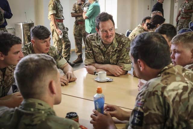 Stephen Morgan, shadow armed forces minister (pictured centre) talking to troops during an engagement visit overseas.
