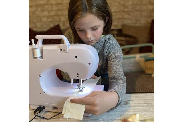 Isabelle Smith, 9 from Havant, has been making and selling scrunchies and raised funds for Children in Need. Pictured: Isabelle working hard to create scrunchies