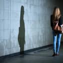 View of woman walking alone at night