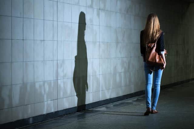 View of woman walking alone at night