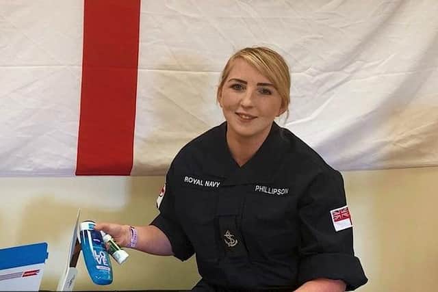 One of he sailors opening a care package sent to her by the RNRMC