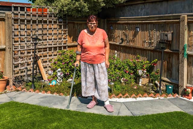 Barbara Collins in the garden where sub-standard landscaping has caused disappointment, stress and a potentially huge bill to put things right. Picture: Mike Cooter (110821)