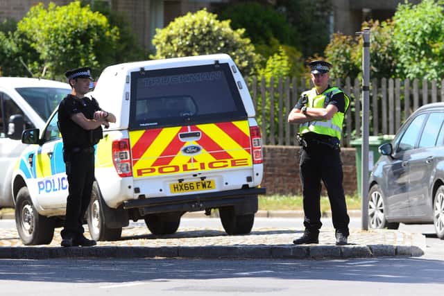 File photo of police seen in Wickham Square, Wickham, in 2020. Sarah Standing (200520-2317)