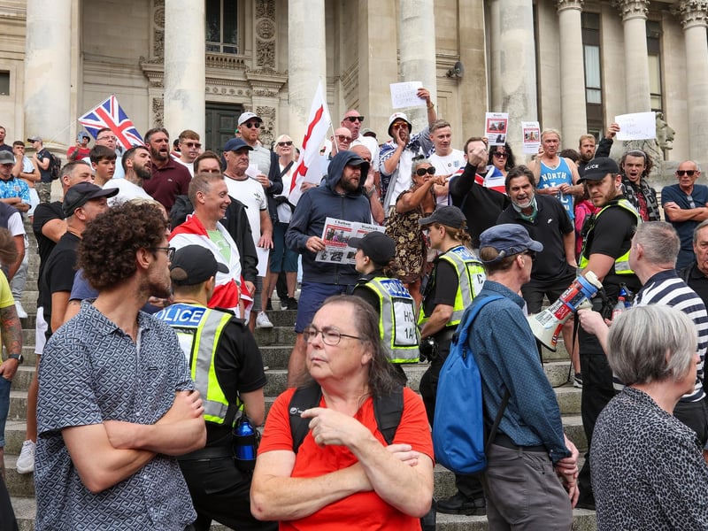 Protestors at Guildhall Square, Portsmouth. Counter demonstrators in the foreground. Picture: Chris  Moorhouse (030824-24)