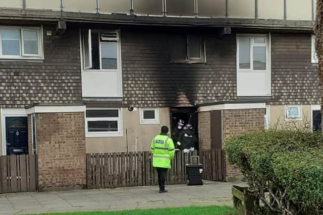 Fire investigation officers at the Seymour Close flat after a suspected arson attack.