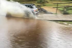 A driver speeds through a New Forest ford leaving their car with damage to its front