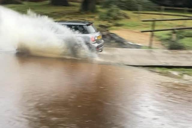 A driver speeds through a New Forest ford leaving their car with damage to its front